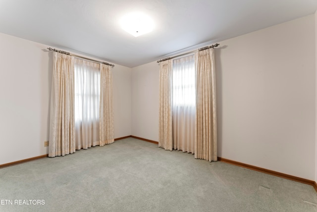 carpeted spare room with a healthy amount of sunlight