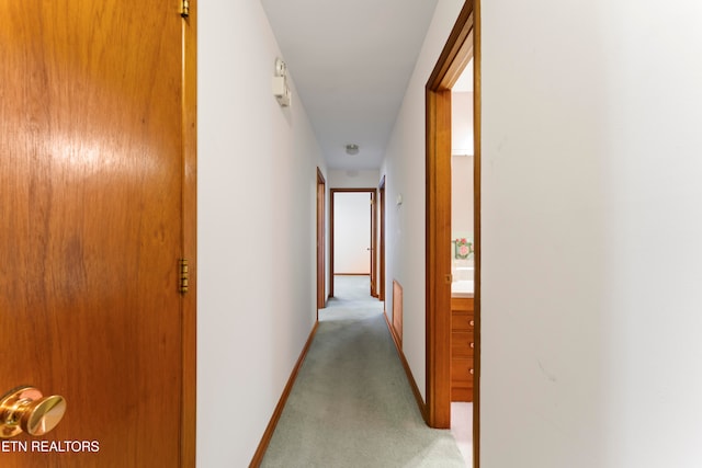 hallway with light colored carpet