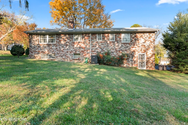 back of property featuring a lawn