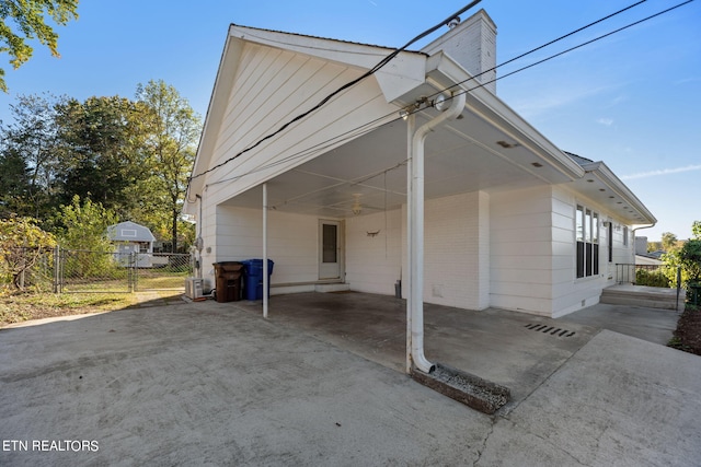 view of side of property with a carport