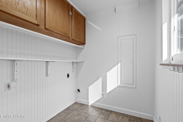 laundry area with cabinets, ornamental molding, wooden walls, and electric dryer hookup