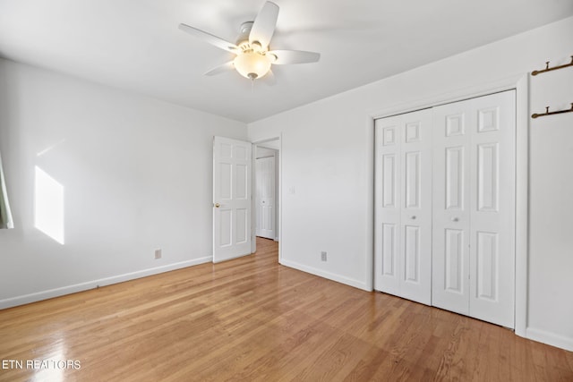 unfurnished bedroom featuring a closet, light hardwood / wood-style floors, and ceiling fan