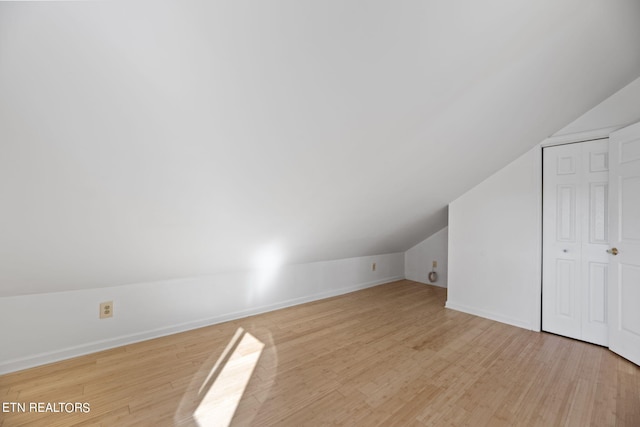 bonus room with light hardwood / wood-style floors and lofted ceiling