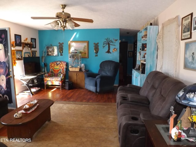 living room featuring ceiling fan and wood-type flooring