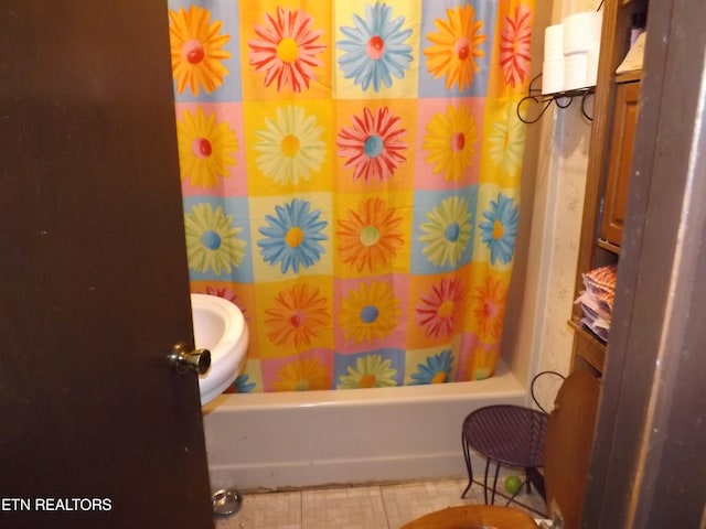 bathroom with tile patterned floors and shower / tub combo