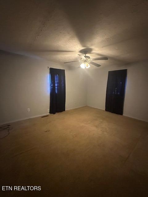 spare room featuring ceiling fan and carpet flooring