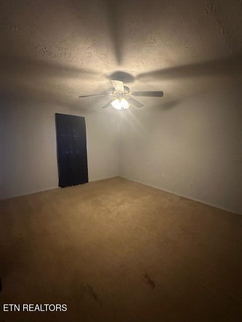 spare room with ceiling fan and a textured ceiling