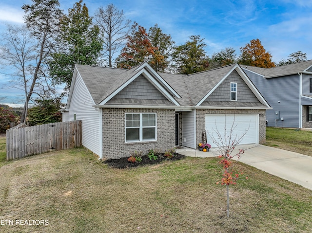 view of front of house featuring brick siding, an attached garage, fence, driveway, and a front lawn