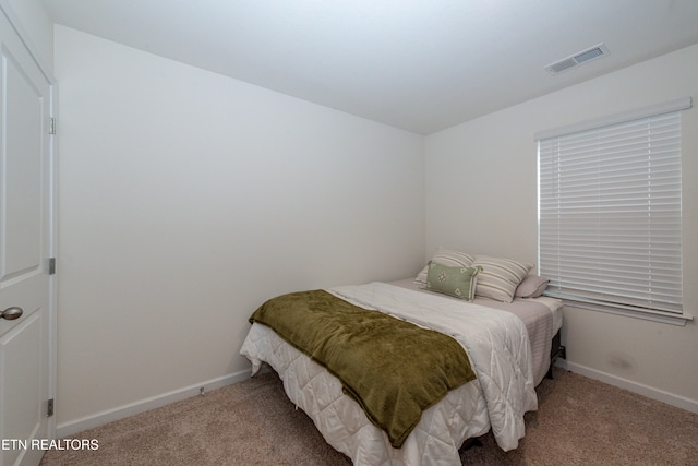 bedroom featuring light carpet