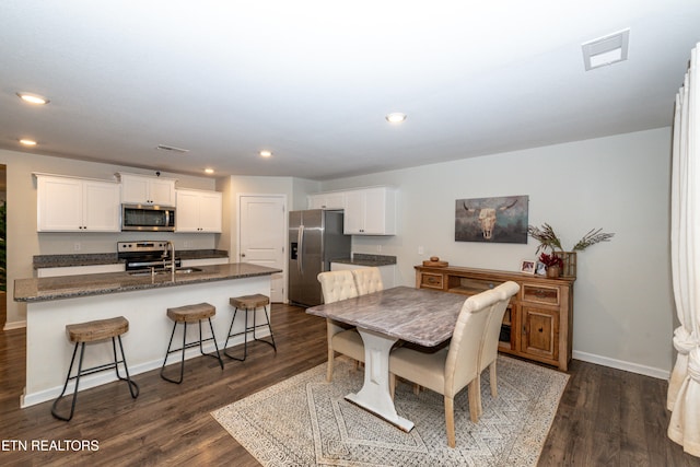 dining area with sink and dark hardwood / wood-style flooring