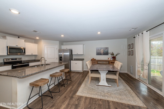 dining space featuring sink and dark hardwood / wood-style flooring