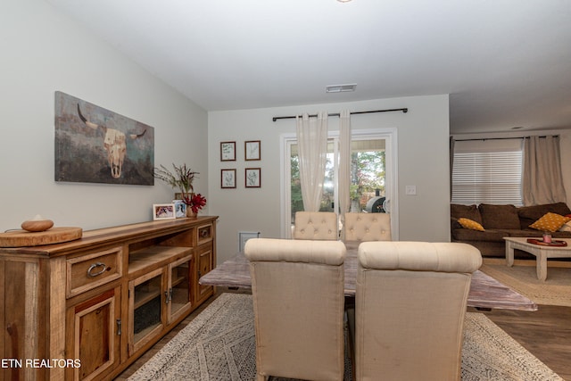 dining room featuring dark wood-style flooring and visible vents