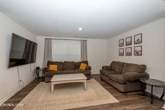 living room with dark hardwood / wood-style flooring