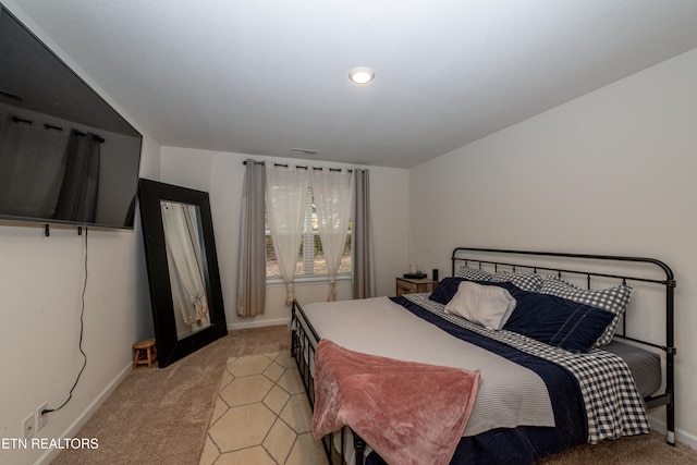 bedroom featuring light colored carpet, visible vents, and baseboards