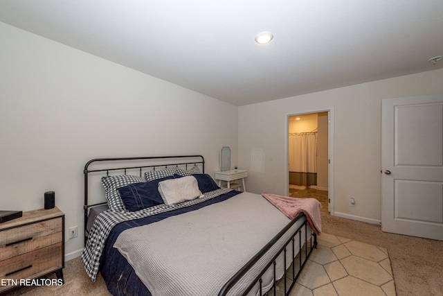 carpeted bedroom featuring ensuite bathroom