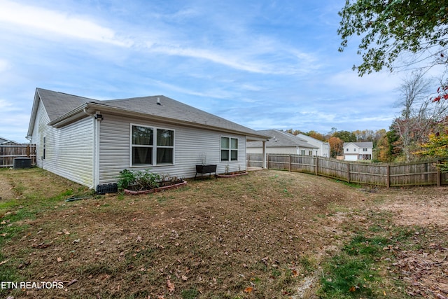 back of house with central AC unit