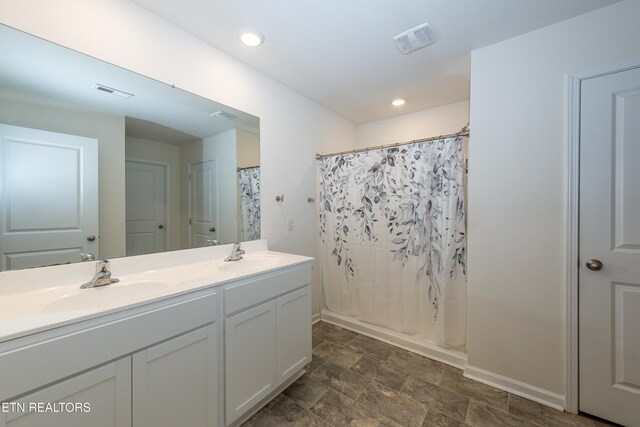 full bath with shower / bath combo, visible vents, and a sink