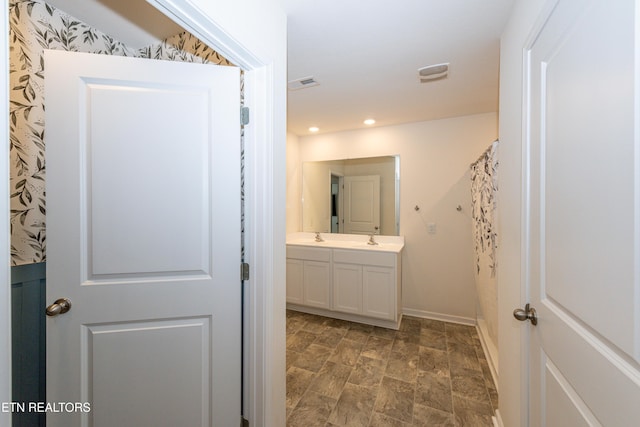 full bathroom with double vanity, recessed lighting, visible vents, and baseboards