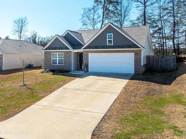 view of front of home with an attached garage, brick siding, fence, driveway, and a front lawn