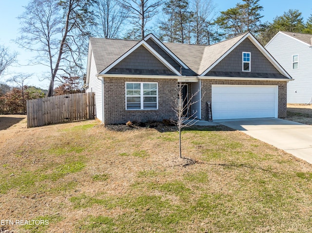 view of front facade featuring a garage, fence, a front lawn, and concrete driveway