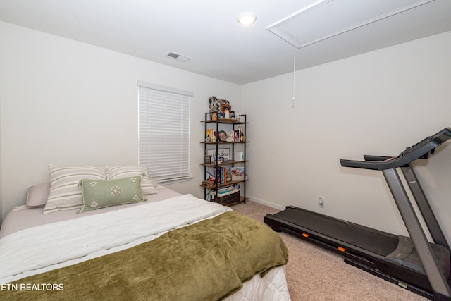 bedroom with visible vents, baseboards, attic access, and light colored carpet