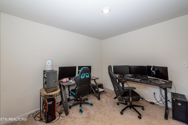 office space with baseboards and light colored carpet