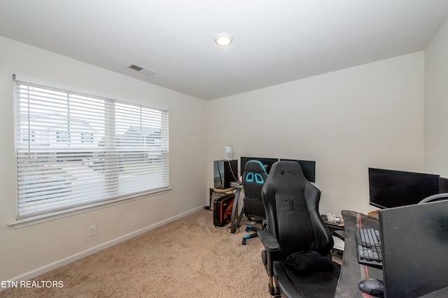 home office featuring light carpet, visible vents, and baseboards