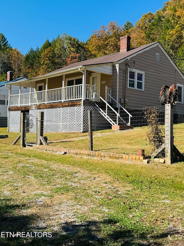 back of property featuring a lawn