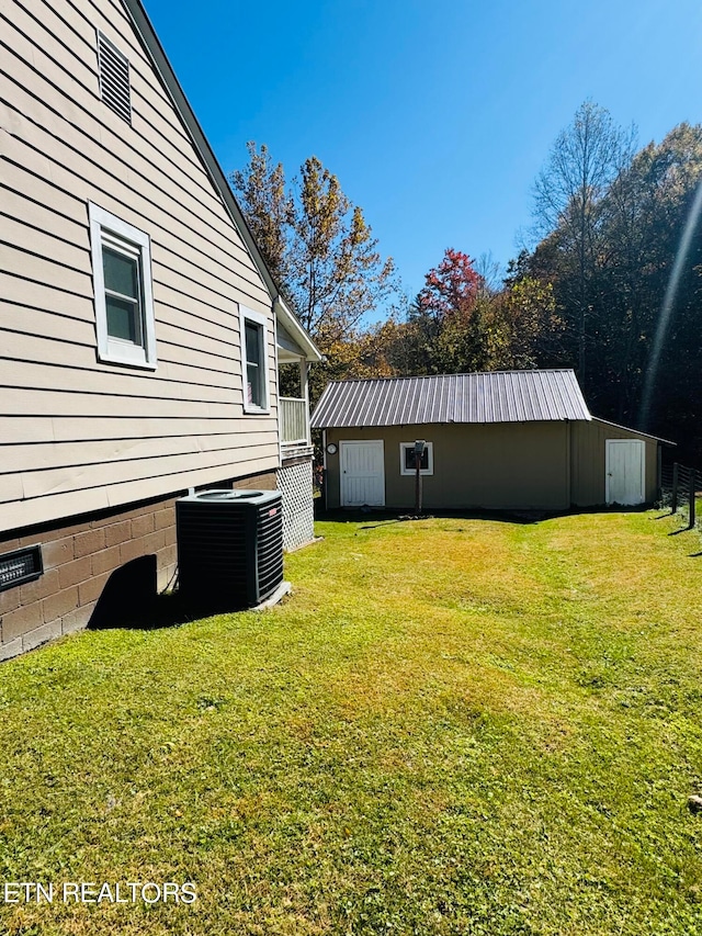 view of yard featuring an outdoor structure and central air condition unit