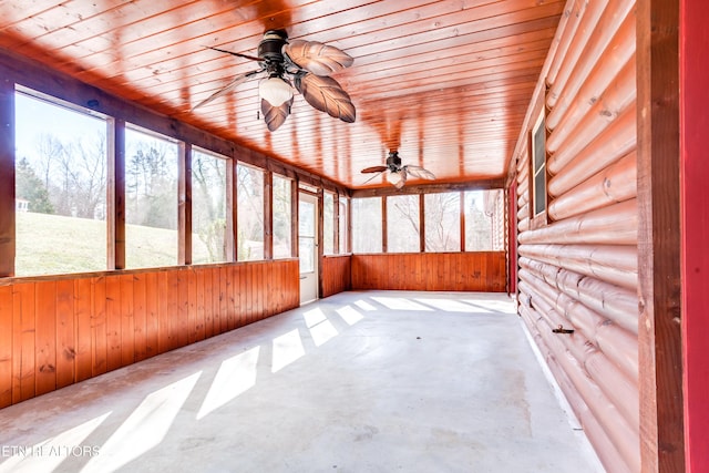 unfurnished sunroom with wood ceiling and ceiling fan