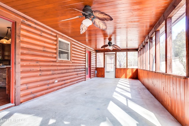 unfurnished sunroom featuring wooden ceiling and ceiling fan