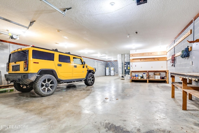 garage with a garage door opener and a workshop area