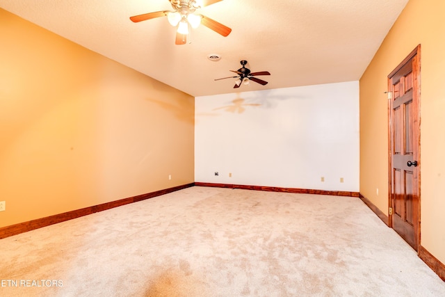 unfurnished room featuring ceiling fan and carpet flooring