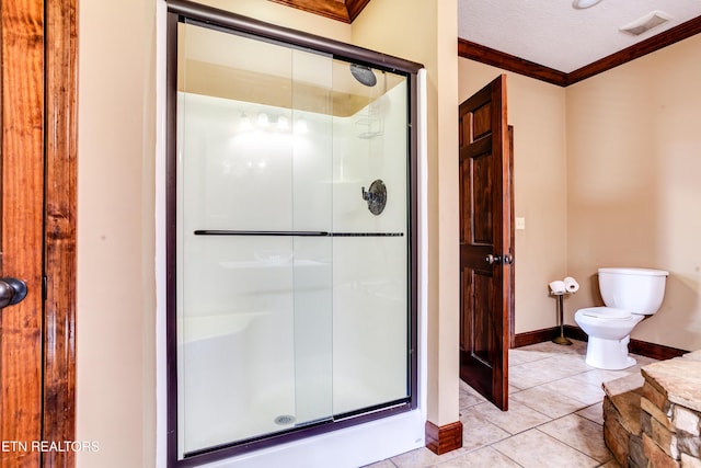 bathroom with toilet, an enclosed shower, a textured ceiling, ornamental molding, and tile patterned flooring