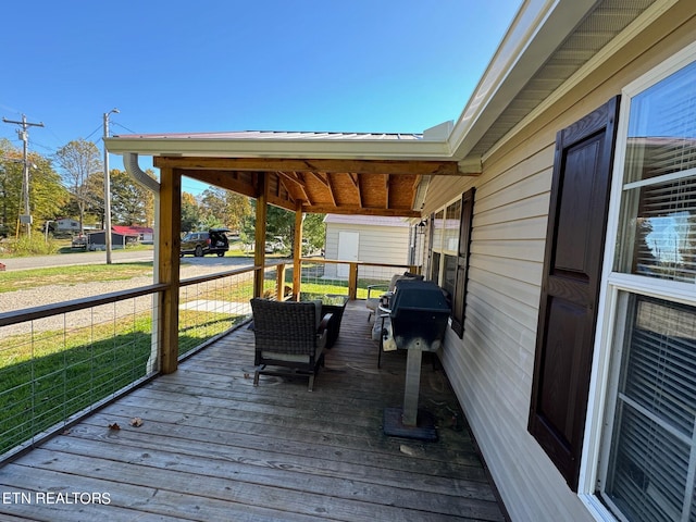 wooden deck with a grill