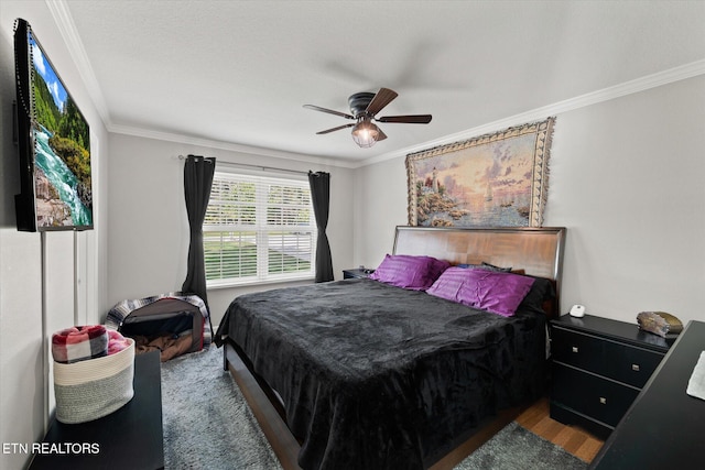 bedroom featuring ornamental molding, hardwood / wood-style flooring, and ceiling fan