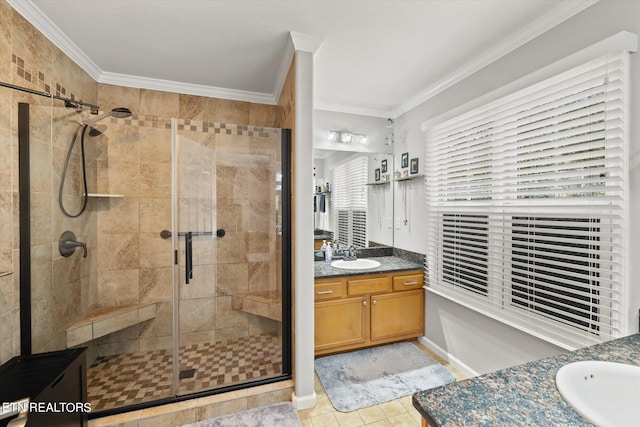 bathroom featuring vanity, tile patterned floors, ornamental molding, and an enclosed shower