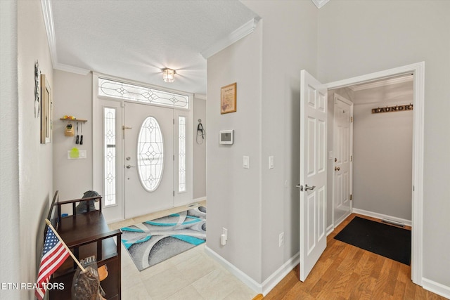 foyer featuring crown molding, a textured ceiling, and wood-type flooring