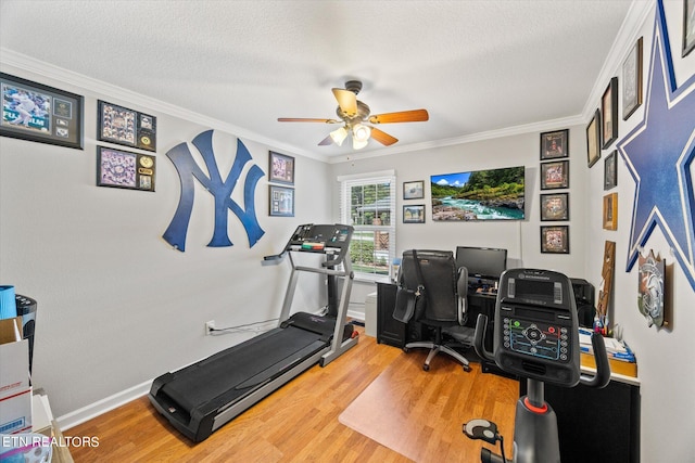 workout room with ornamental molding, hardwood / wood-style flooring, a textured ceiling, and ceiling fan