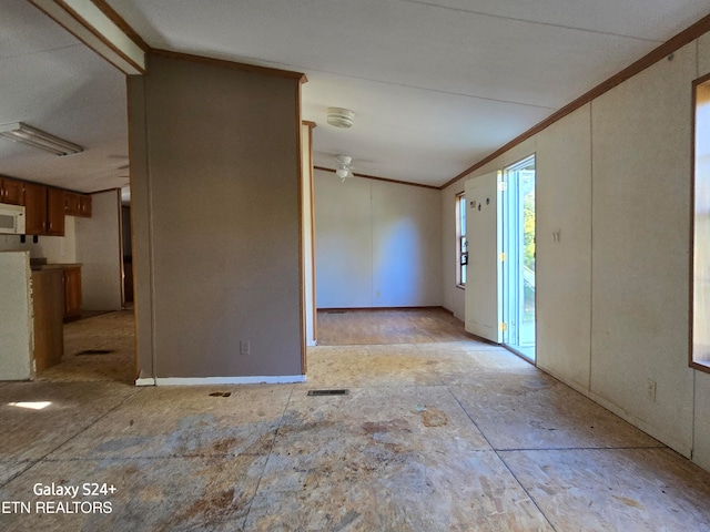 entryway with lofted ceiling, crown molding, and ceiling fan