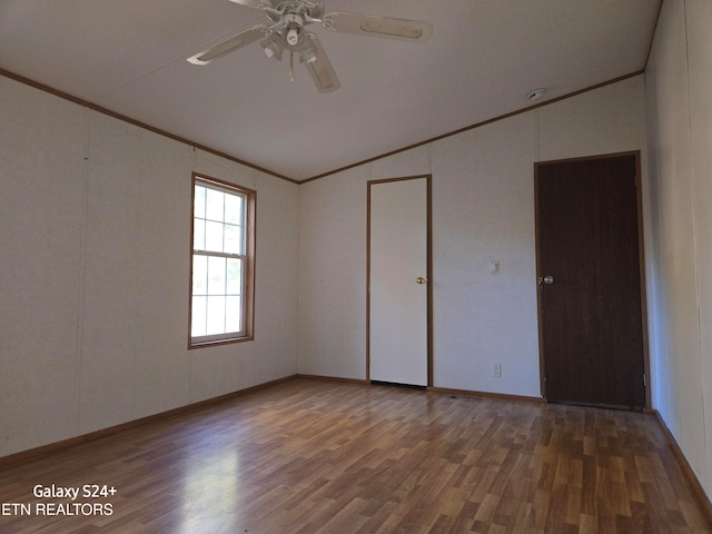 unfurnished bedroom with ceiling fan, hardwood / wood-style flooring, ornamental molding, and lofted ceiling