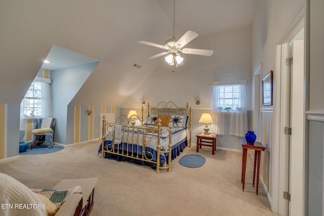 bedroom featuring ceiling fan, carpet flooring, multiple windows, and vaulted ceiling