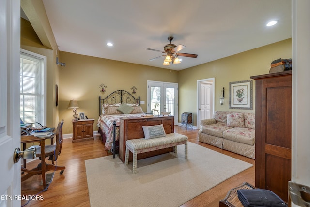 bedroom featuring french doors, light hardwood / wood-style floors, and ceiling fan