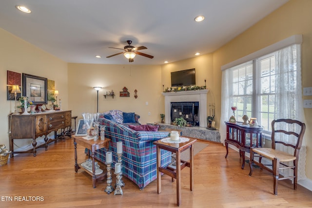 living room with ceiling fan and hardwood / wood-style flooring