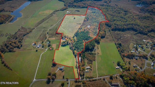 birds eye view of property with a water view and a rural view