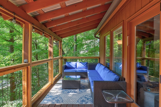 sunroom / solarium featuring lofted ceiling