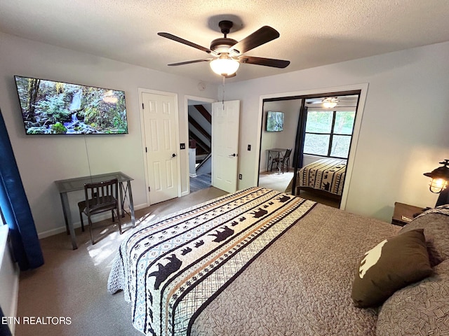 carpeted bedroom featuring a closet, a textured ceiling, and ceiling fan