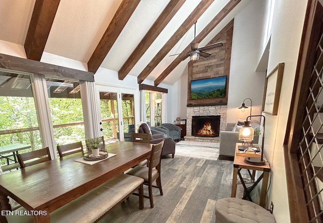 dining room with beamed ceiling, dark wood-type flooring, a fireplace, and high vaulted ceiling