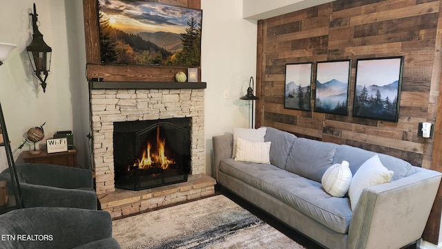 living room featuring a stone fireplace