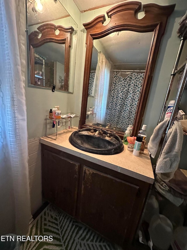 bathroom featuring vanity and a textured ceiling